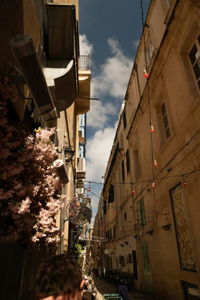 Narrow street in Malta decorated with festive lights